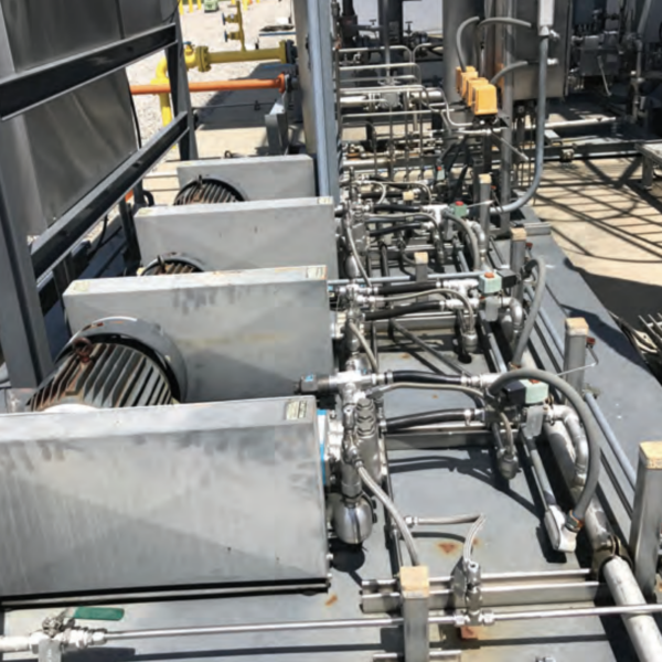 Industrial setup featuring multiple electric motor-driven pumps before upgrading to seal-flushed pumps