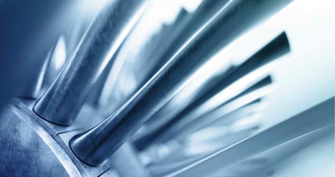 Close-up of metallic, polished prongs arranged in a fan shape, creating an abstract, sleek, and modern design.