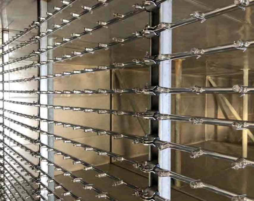 Close-up of a metallic rack system featuring evenly spaced horizontal bars with connectors, set against a muted background.