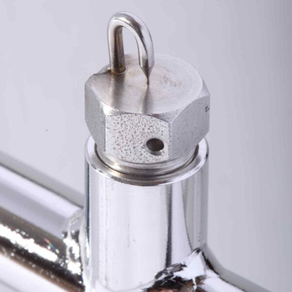 Close-up of a metal valve featuring a hexagonal top and a small hook, polished chrome finish with visible threading and an opening.
