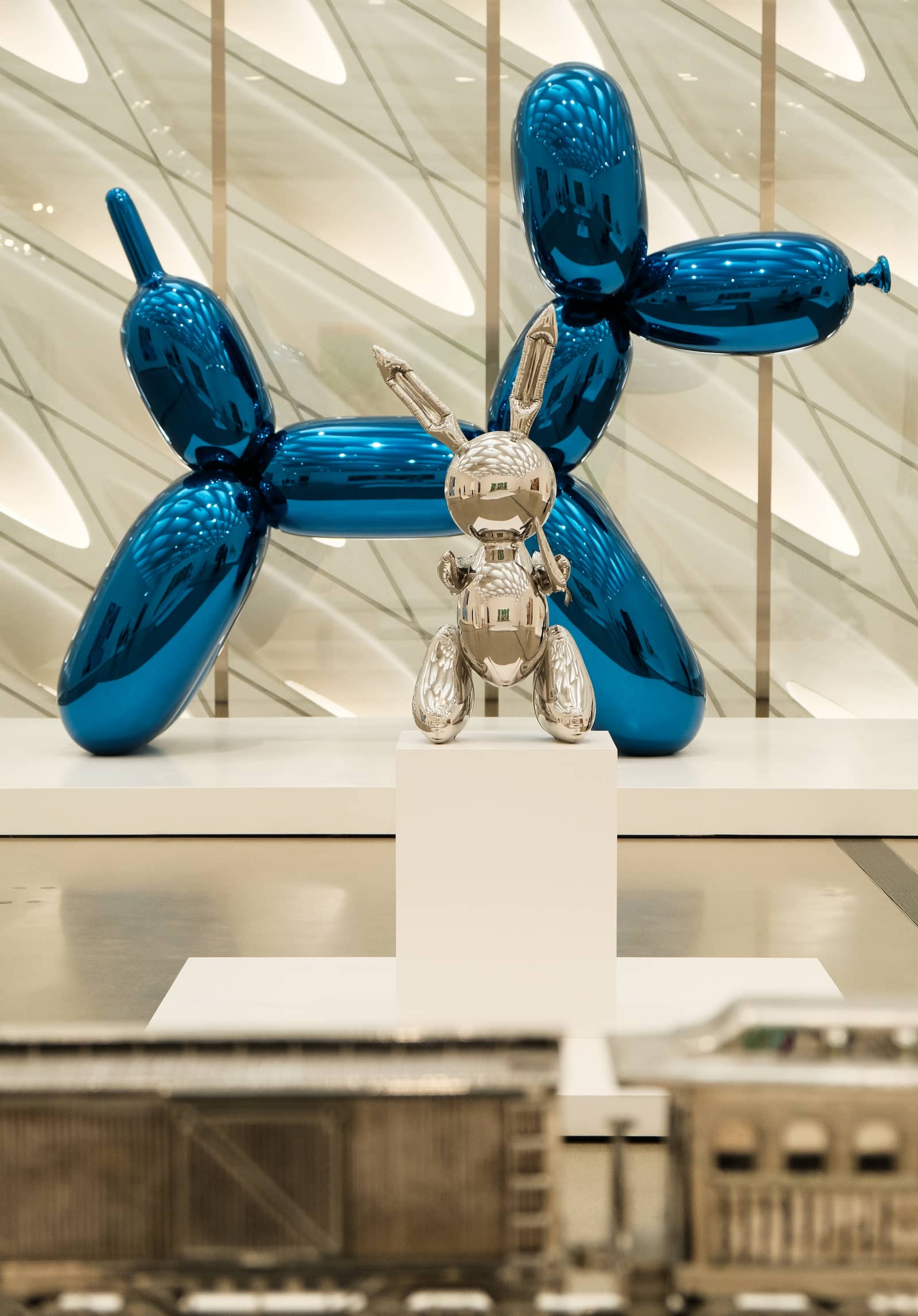 Balloon Dog (Blue) and Rabbit by artist Jeff Koons on display at The Broad museum in Los Angeles. The blue color is achieved through a specialized transparent chromatic coating layered over the mirror-polished steel