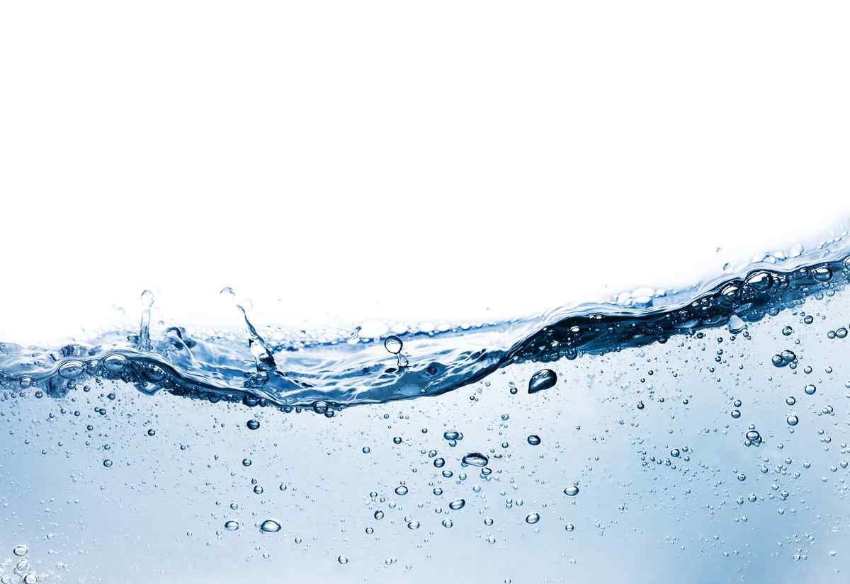 Close-up of a wave of clear water, creating bubbles with a bright white background, evoking a refreshing and vibrant feel.